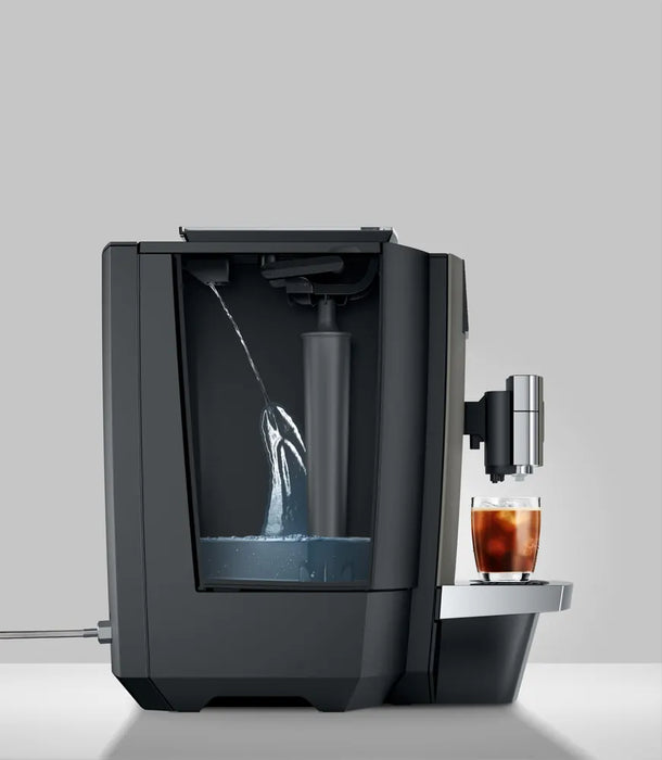 JURA X10c Dark Inox koffiemachine met waterreservoir en glas met ijskoffie